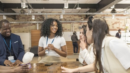 students around a table in London campus