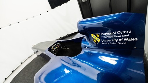 Blue motorsport vehicle with UWN branding