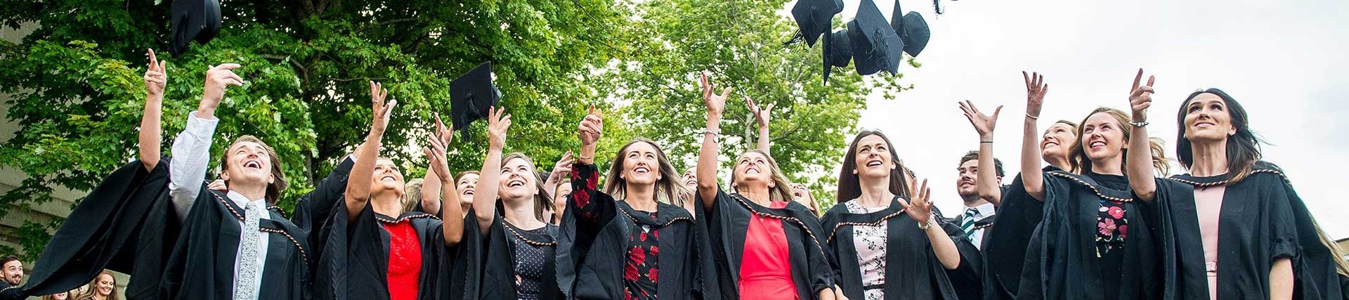 a group of students throwing hats in the air
