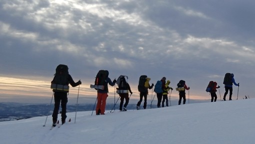 Students walking on snow-capped mountain