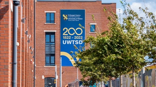 Branded 200 years banner on the side of the IQ building in Swansea