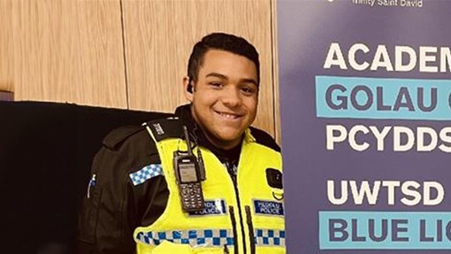 Policing students standing in front of a UWN Blue Light banner