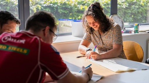Students noting down ideas at a table